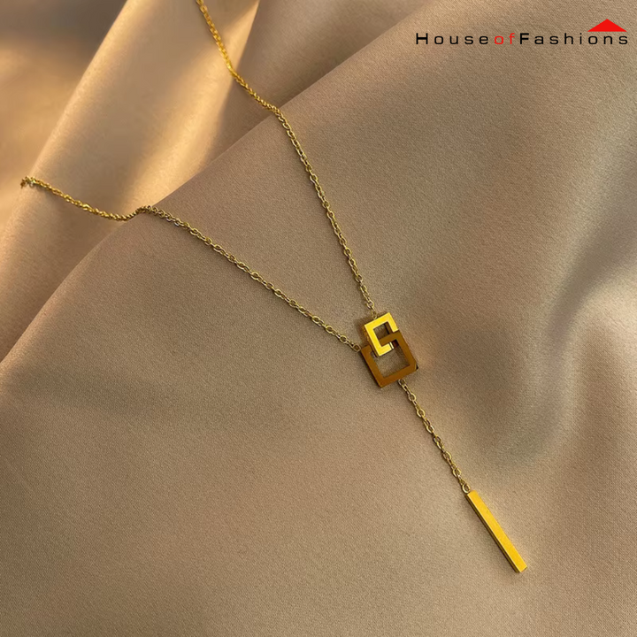 18K Gold Plated Square Link Necklace on beige fabric, showcasing its elegant square link and bar pendant design.