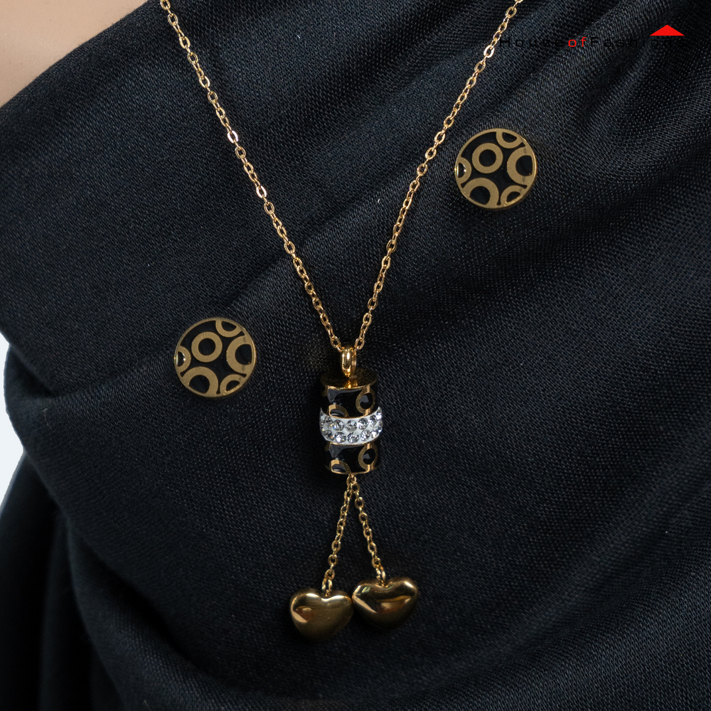 3-Piece 18K Gold Plated Jewelry Set with circle earrings and heart pendant necklace on black fabric background