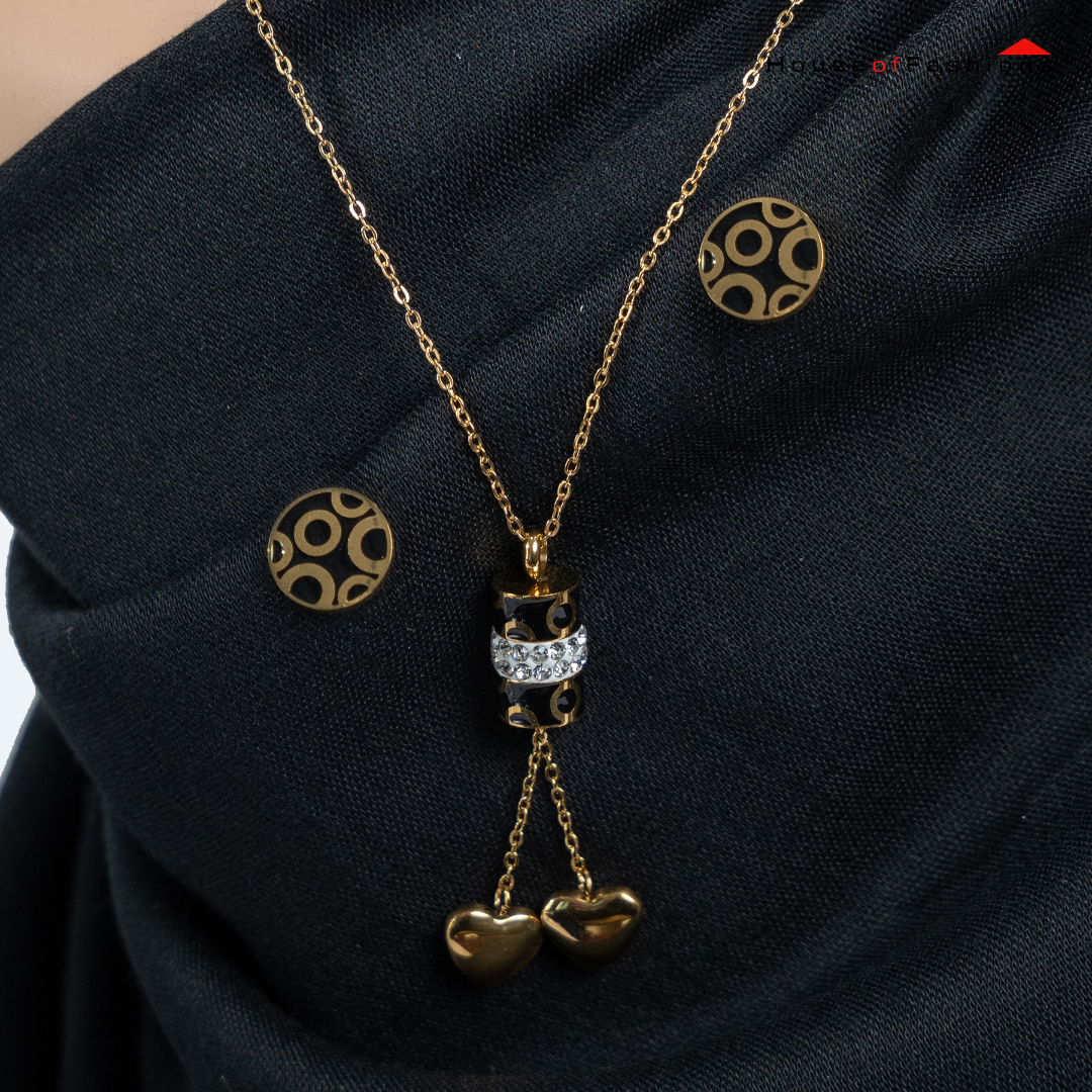 3-Piece 18K Gold Plated Jewelry Set with circle earrings and heart pendant necklace on black fabric background