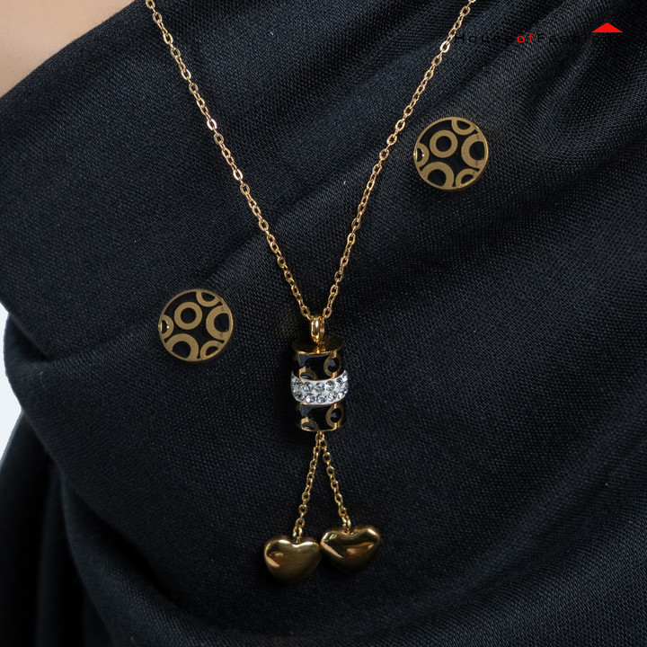 3-Piece 18K Gold Plated Jewelry Set with circle earrings and heart pendant necklace on black fabric background