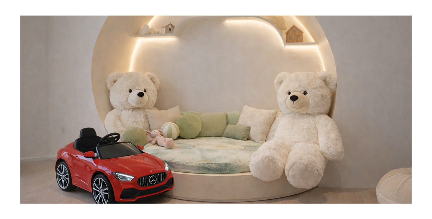Large teddy bear and big toy car in children’s play area.
